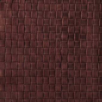 Brown leather texture with a quilted rectangular grid pattern, displaying natural grain and a matte, distressed finish.
